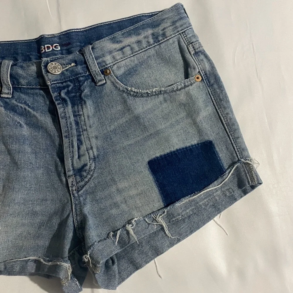 BDG High Rise Button Fly Distressed & Patched Tomgirl Jean Shorts